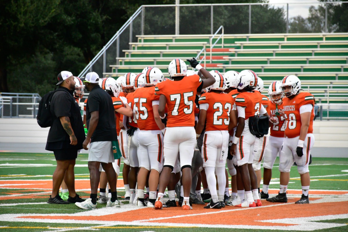 The huddle. #75 in the middle of the orange paint.